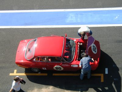 mechanics tinker with a car